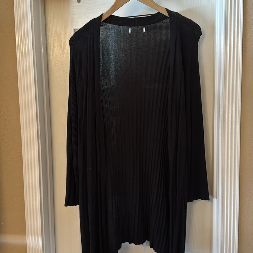 Long sweater with shorter sleeves.